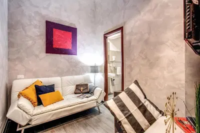 a living room with a white couch and a chair at La Residenza Dell'Angelo in Rome