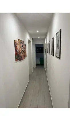 a hallway with paintings on the walls of a room at Les Artes in Rome
