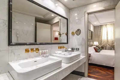 a bathroom with two sinks and a large mirror at Hotel Lunetta in Rome