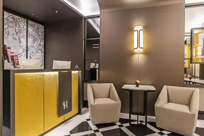 a lobby with two chairs and a table and lights at Hotel Lunetta in Rome