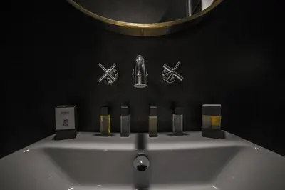 a sink in a bathroom with a mirror and some candles at SuiteLifeTrevi in Rome