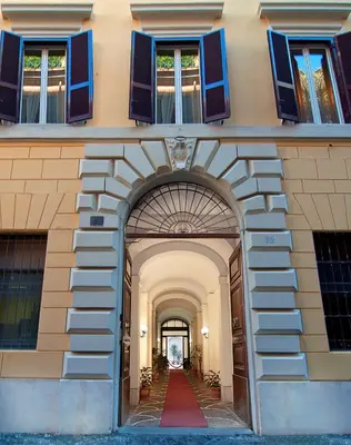 an entrance to a building with blue windows and a red carpet at Le Clarisse Pantheon in Rome