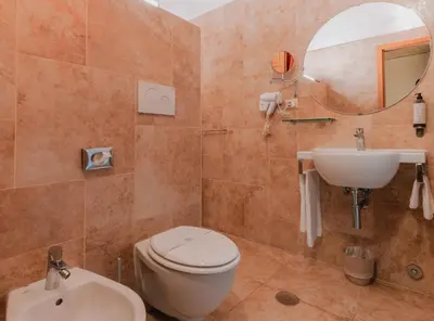 a bathroom with a toilet and a sink and a mirror at Le Clarisse Pantheon in Rome
