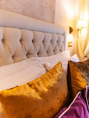 a white bed with a large pillow on it at Le Clarisse Pantheon in Rome