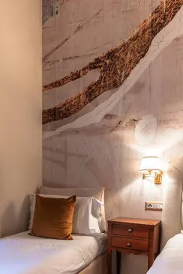 a bedroom with a bed with a painting on the wall at Le Clarisse Pantheon in Rome