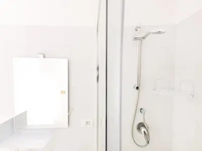 a shower in a bathroom with a mirror at Cielo Vaticano Guest House in Rome