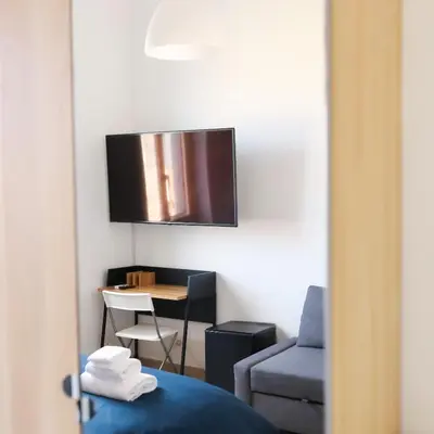 a room with a bed and a chair and a table at Cielo Vaticano Guest House in Rome