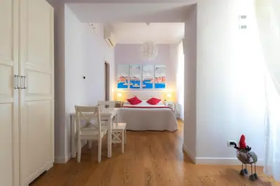 a bedroom with a bed and a table and chairs at QuodLibet in Rome
