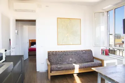 a living room with a couch and a table at BEACHBAR Apartment in Rome in Rome