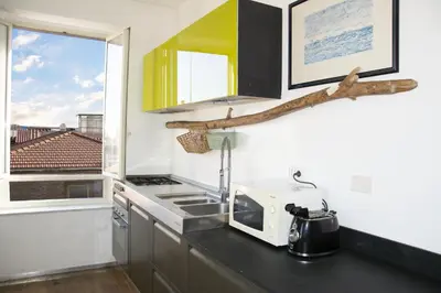 a kitchen with a counter with a sink and a microwave at BEACHBAR Apartment in Rome in Rome