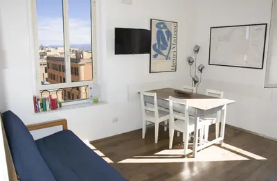 a living room with a table and a couch and a table and chairs at BEACHBAR Apartment in Rome in Rome