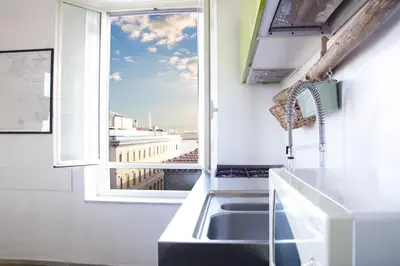 a kitchen with a sink and a window at BEACHBAR Apartment in Rome in Rome