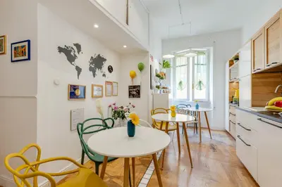 a kitchen and dining room with two tables and chairs at Maison Vantaggio in Rome