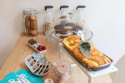 a table with a tray of pastries and desserts at Maison Vantaggio in Rome