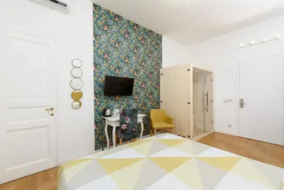a bedroom with a bed and a tv on a wall at Maison Vantaggio in Rome