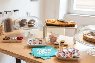a table with various pastries and desserts on it at Maison Vantaggio in Rome
