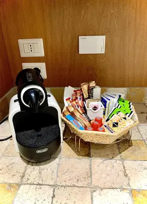 a hair dryer sitting on a counter next to a basket at Tito Suite Guest House in Rome