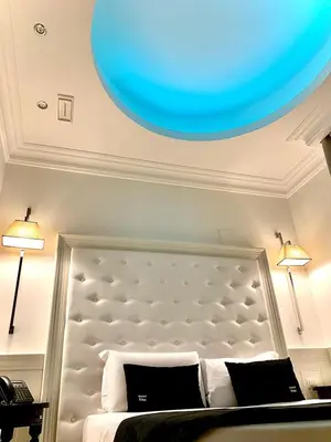 a bedroom with a bed with a blue ceiling at Tito Suite Guest House in Rome