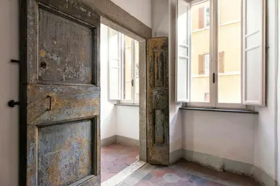 an open door in a room with windows at Canova Rooms in Spanish Steps in Rome