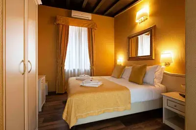 a bedroom with a bed and a window at Canova Rooms in Spanish Steps in Rome