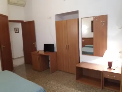 a bedroom with a bed and a dresser and a mirror at Ritmo Blues Guest House in Rome