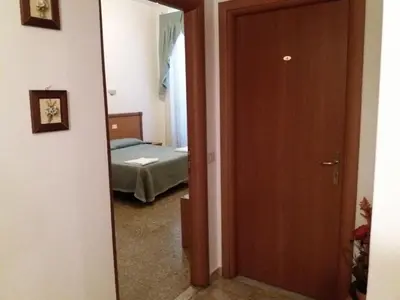 a door leading to a bedroom with a bed at Ritmo Blues Guest House in Rome