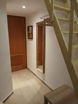 a room with a staircase with a mirror and a door at Ritmo Blues Guest House in Rome
