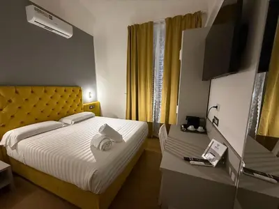 a hotel room with a bed and a television at Conte GuestHouse in Rome