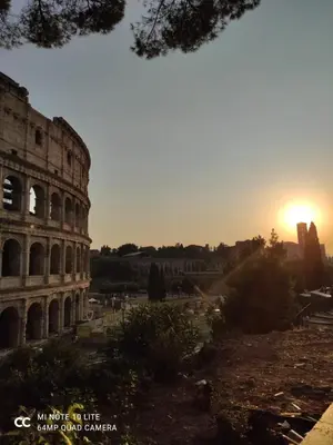 an image of the coliseum with the sunset in the background at Conte GuestHouse in Rome
