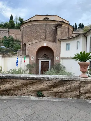 a building with a brick wall with flags in front of it at Foro Romano Apartments B in Rome