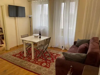 a living room with a table and a couch at Foro Romano Apartments B in Rome