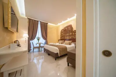 a hotel room with a bed and a bathroom at Maison Tritone in Rome