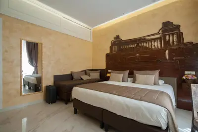 a bedroom with a large bed and a couch at Maison Tritone in Rome