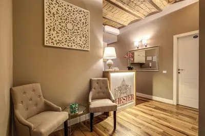 a living room with two chairs and a mirror at Chester Suites in Rome