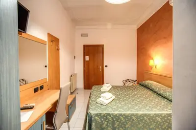 a hotel room with a bed and a mirror at Hotel Millerose in Rome