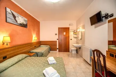 a hotel room with two beds and a bathroom at Hotel Millerose in Rome