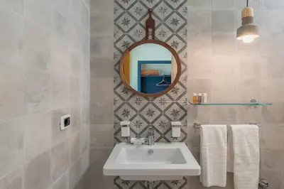 a bathroom with a sink and a mirror at DAB Guest House in Rome