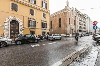 a city street with cars and a person riding a bike at DAB Guest House in Rome