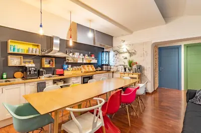 a kitchen with a wooden table and colorful chairs at DAB Guest House in Rome