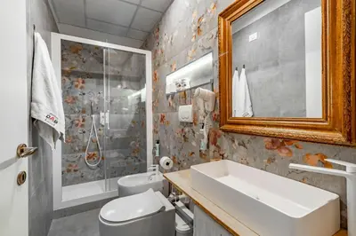a bathroom with a sink and a toilet and a mirror at DAB Guest House in Rome