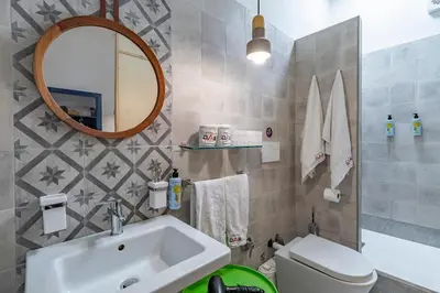 a bathroom with a sink and a toilet and a mirror at DAB Guest House in Rome