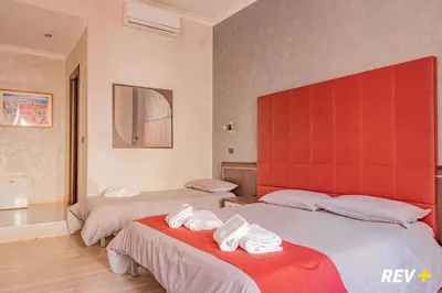 a hotel room with two beds with towels on them at New Inn in Rome