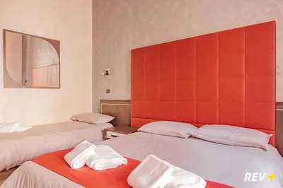 a room with two beds with towels on them at New Inn in Rome