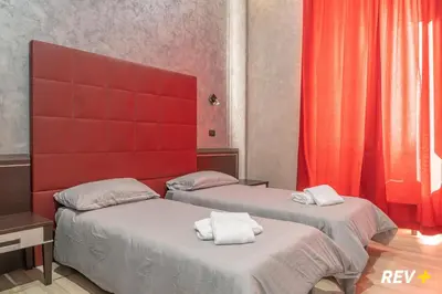 two beds with towels on them in a room at New Inn in Rome