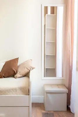 a bedroom with a bed and a mirror at CLAVDIA Flat in Rome