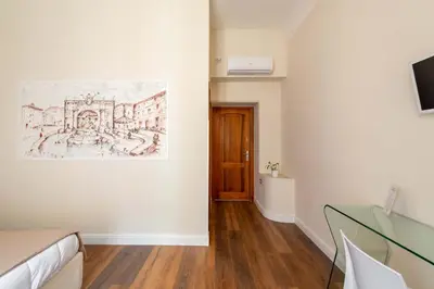 a room with a drawing on the wall and a glass table at CLAVDIA Flat in Rome