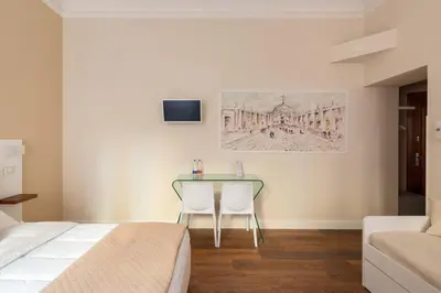 a bedroom with a bed and a table and chairs at CLAVDIA Flat in Rome