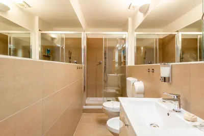 a bathroom with a toilet and a sink and a shower at CLAVDIA Flat in Rome