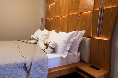 a bedroom with a bed with white pillows at Unicum Vite in Rome