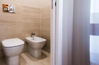 a bathroom with a toilet and a sink at Unicum Vite in Rome